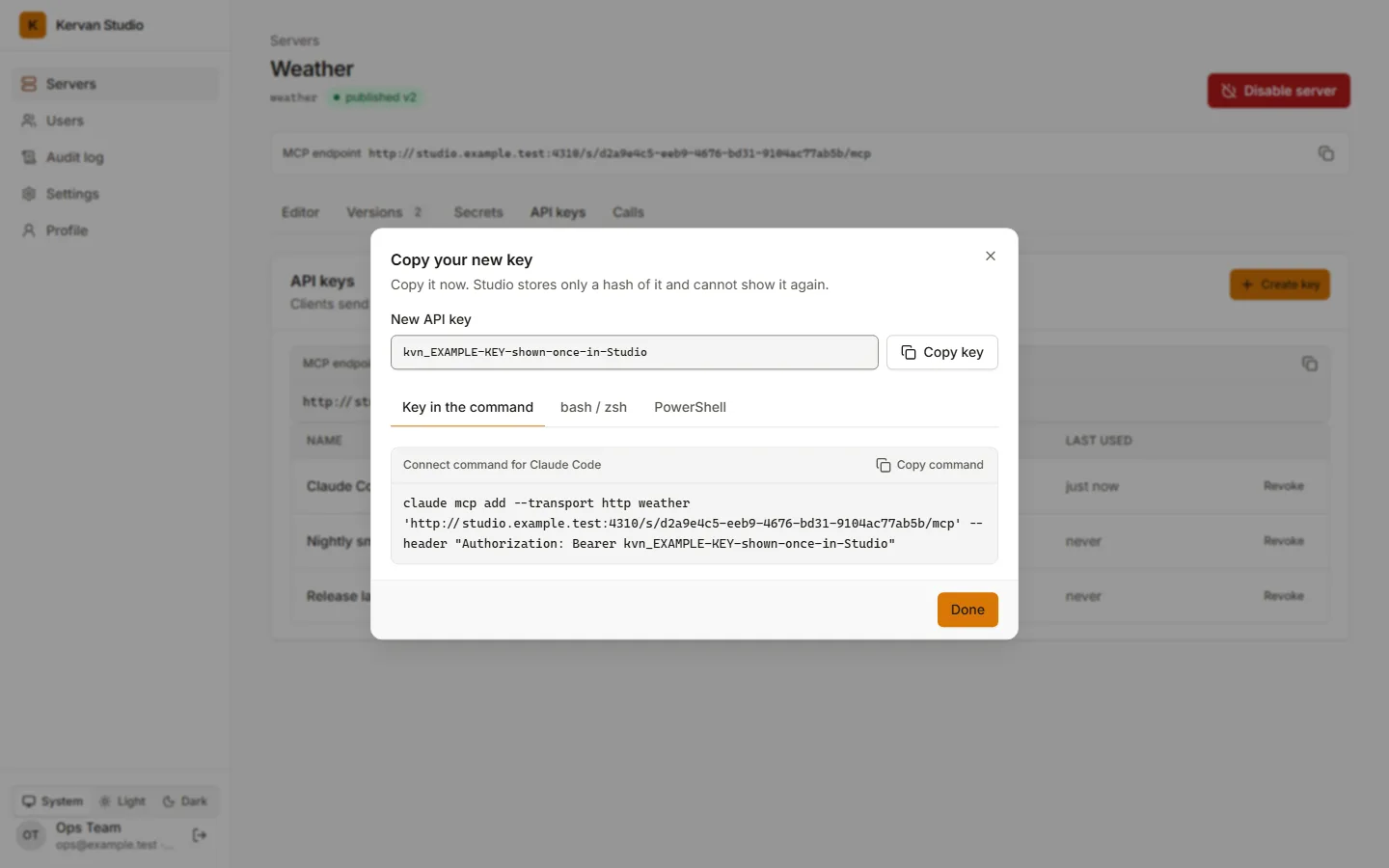 The new-key dialog: the key in a read-only field and the claude mcp add command with the key in it.
